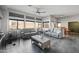 Spacious living room with plush gray sofas, large windows, ceiling fan and neutral tones at 11840 N 59Th Ln, Glendale, AZ 85304