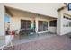 Covered patio area with patio furniture and a well-maintained brick-paved surface, perfect for outdoor relaxation at 11840 N 59Th Ln, Glendale, AZ 85304