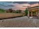 Private backyard featuring rock landscaping, a covered patio, and mature trees at 121 W Hackberry Dr, Chandler, AZ 85248