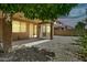 The back patio is covered with a slider entry to home; rock landscaping surrounds yard at 121 W Hackberry Dr, Chandler, AZ 85248