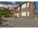 Back exterior view with covered patio, rock landscaping, and views of the second story windows at 121 W Hackberry Dr, Chandler, AZ 85248