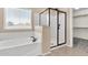 Bathroom featuring a soaking tub, separate glass shower, neutral colors, and tile flooring at 121 W Hackberry Dr, Chandler, AZ 85248