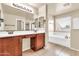 Bathroom featuring a double sink vanity with cherry wood cabinets, tile flooring, and a soaking tub at 121 W Hackberry Dr, Chandler, AZ 85248