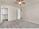 Bedroom with plush carpeting, a ceiling fan, and access to a walk-in closet at 121 W Hackberry Dr, Chandler, AZ 85248