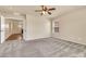 Bright bedroom featuring plush carpet, a ceiling fan, and natural light at 121 W Hackberry Dr, Chandler, AZ 85248