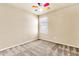 This bedroom offers neutral walls, carpet and a colorful ceiling fan above at 121 W Hackberry Dr, Chandler, AZ 85248