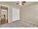 Neutral bedroom with carpet, standard closet and a multi-color ceiling fan at 121 W Hackberry Dr, Chandler, AZ 85248