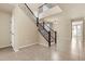 Bright entryway featuring tile floors and an open staircase with dark wood railings at 121 W Hackberry Dr, Chandler, AZ 85248