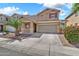 Charming home with a two-car garage, stone accents, and a beautifully landscaped front yard at 121 W Hackberry Dr, Chandler, AZ 85248