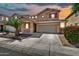 Inviting two-story home featuring a well-manicured front yard and a spacious driveway at 121 W Hackberry Dr, Chandler, AZ 85248