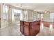 Open kitchen showcasing a large island, tile flooring, and a seamless flow into adjacent living areas at 121 W Hackberry Dr, Chandler, AZ 85248
