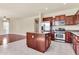 Open-concept kitchen featuring stainless steel appliances, granite counters, an island, and a seamless flow to the living area at 121 W Hackberry Dr, Chandler, AZ 85248