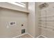 Laundry room with built-in shelving and tile flooring at 121 W Hackberry Dr, Chandler, AZ 85248