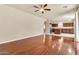 Open-concept living room featuring gleaming hardwood floors and seamless flow to the kitchen at 121 W Hackberry Dr, Chandler, AZ 85248
