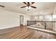 Spacious loft area featuring hardwood floors, a ceiling fan, and views of the lower level at 121 W Hackberry Dr, Chandler, AZ 85248