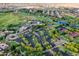 Aerial view of a Primary planned community featuring a golf course, clubhouse, tennis courts, and lush landscaping at 12780 W Desert Vista Trl, Peoria, AZ 85383
