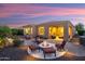 Evening view of the backyard with a fire pit and inviting seating area, perfect for nighttime enjoyment at 12780 W Desert Vista Trl, Peoria, AZ 85383