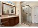 Well-lit bathroom with a glass-enclosed shower, granite countertops, and dark wood cabinets at 12780 W Desert Vista Trl, Peoria, AZ 85383
