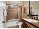 Well-lit bathroom features a shower-tub combo, a decorative tile accent, and a granite countertop at 12780 W Desert Vista Trl, Peoria, AZ 85383