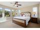 Serene bedroom featuring plush carpeting, ample natural light, and a comfortable queen-sized bed at 12780 W Desert Vista Trl, Peoria, AZ 85383