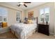 Cozy bedroom features a decorative ceiling fan, shutters, and comfortable window seat at 12780 W Desert Vista Trl, Peoria, AZ 85383