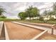 Community bocce ball court situated on a green lawn with mature trees at 12780 W Desert Vista Trl, Peoria, AZ 85383