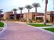 Elegant clubhouse exterior with desert landscaping, palm trees, and a paved entry leading to the building at 12780 W Desert Vista Trl, Peoria, AZ 85383