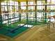 Bright indoor swimming pool with lane markers, large windows, and tiled deck at 12780 W Desert Vista Trl, Peoria, AZ 85383