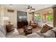 Cozy living room with comfortable seating, a ceiling fan, and plenty of natural light at 12780 W Desert Vista Trl, Peoria, AZ 85383