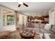 Open-concept living room with sofa, hardwood floors, and view of modern kitchen at 12780 W Desert Vista Trl, Peoria, AZ 85383