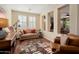 Comfortable living room with hardwood floors and plantation shutters adjacent to sitting area at 12780 W Desert Vista Trl, Peoria, AZ 85383