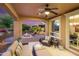 Covered patio with comfortable seating and a ceiling fan, offering a relaxing outdoor living space at 12780 W Desert Vista Trl, Peoria, AZ 85383