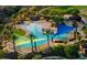 Aerial shot of a resort-style community pool with colorful shade structures and poolside seating at 12780 W Desert Vista Trl, Peoria, AZ 85383