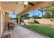 Covered patio and backyard featuring a swimming pool, lush lawn, and a built-in outdoor bar at 1381 N Alexis Dr, Gilbert, AZ 85234