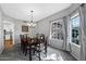 Bright dining room with elegant chandelier, large window, and a classic dining set at 1381 N Alexis Dr, Gilbert, AZ 85234