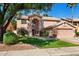 Inviting two-story home features a well-manicured lawn and a charming, classic design at 1381 N Alexis Dr, Gilbert, AZ 85234