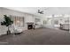 Open-concept living room featuring a fireplace, large windows, and modern finishes at 1381 N Alexis Dr, Gilbert, AZ 85234