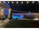 Pool at night with string lights above at 1381 N Alexis Dr, Gilbert, AZ 85234