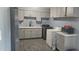 Well-organized laundry room with washer, dryer, microwave, and ample storage space at 14620 N 31St Ln, Phoenix, AZ 85053