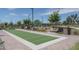 An inviting bocce ball court is ready for residents to enjoy with lush landscaping and nearby benches at 15784 W Soft Wind Dr, Surprise, AZ 85387