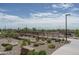 Scenic pedestrian bridge and path amidst a desert landscape, inviting for leisurely strolls and outdoor enjoyment at 15784 W Soft Wind Dr, Surprise, AZ 85387
