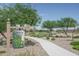First hole of the disc golf course featuring a map, signage, and lush green fairway, perfect for outdoor recreation at 15784 W Soft Wind Dr, Surprise, AZ 85387