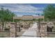 Inviting entrance to Gregory Wayne Fulton Disc Golf Course with stone pillars and manicured landscaping for outdoor recreation at 15784 W Soft Wind Dr, Surprise, AZ 85387