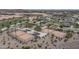 Aerial view of fenced pickleball courts with lush landscaping and seating at 15784 W Soft Wind Dr, Surprise, AZ 85387