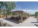 Covered picnic area with multiple tables and benches, ideal for outdoor gatherings and community events at 15784 W Soft Wind Dr, Surprise, AZ 85387