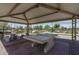 Covered picnic area with table and benches, enhancing outdoor entertainment and community gatherings at 15784 W Soft Wind Dr, Surprise, AZ 85387
