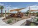 Playground featuring shaded slides, climbing structures, picnic tables, and landscaped surroundings for Gathering fun at 15784 W Soft Wind Dr, Surprise, AZ 85387