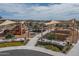 Aerial view of a playground with sunshades, slides, climbing structures, picnic tables, and manicured landscaping at 15784 W Soft Wind Dr, Surprise, AZ 85387