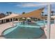 Modern pool area with splash pad and shaded tables at 15784 W Soft Wind Dr, Surprise, AZ 85387