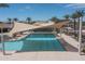 Modern pool with clear water and shaded lounge area at 15784 W Soft Wind Dr, Surprise, AZ 85387